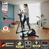 A woman is using a crosstrainer in a living room. Produktbild-Vorschau