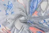 A close-up view of a soft, gray blanket with a space-themed pattern featuring astronauts, planets, and rockets. Náhled obrázku produktu
