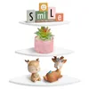 Three white corner shelves with decorative items on each shelf. Produktbild-Vorschau