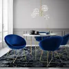A dining room set with blue velvet chairs and a white marble table. Náhled obrázku produktu