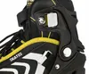 A close-up view of a black and yellow inline skate, focusing on the buckle and lacing system. Voir les images du produit