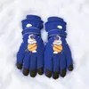 A pair of blue children's winter gloves with an astronaut and planet design, lying on a bed of snow. Produktbild-Vorschau