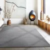 A modern living room with a fireplace, artwork, and a large rug. Náhled obrázku produktu