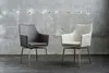 Two chairs are placed in front of a concrete wall. Produktbild-Vorschau