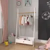 A child's wardrobe rack with clothes hanging on it and a storage bin below, set in a nursery or playroom. Voir les images du produit