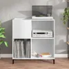 A white record player stand with a record player on top, a receiver in the middle shelf, and vinyl records and books on the bottom shelf. Náhled obrázku produktu
