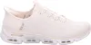 A side view of a beige Skechers slip-on shoe. Voir les images du produit