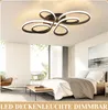 A modern bedroom with a large window, bed, and a unique ceiling light. Produktbild-Vorschau