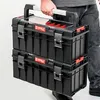 A person is holding a stack of two Qbrick System toolboxes. Anteprima dell’immagine prodotto