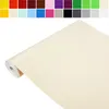 A roll of beige adhesive film or wallpaper. Produktbild-Vorschau