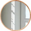 A round mirror with a wooden frame, reflecting light and shadows from a window. Produktbild-Vorschau