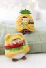 Two plush toys are sitting on a textured green surface, with blurred lights in the background. Produktbild-Vorschau