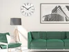 A modern living room with a green sofa, a floor lamp, and a wall clock. Produktbild-Vorschau