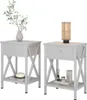 Two white bedside tables are shown against a white background. One table has a vase with greenery and a decorative object on its shelf. The other table has a lamp and decorative items on its shelf. Voir les images du produit
