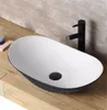 A modern bathroom sink with a black faucet on a wooden countertop. Anteprima dell’immagine prodotto