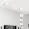 A modern interior with white walls and ceiling, featuring two round LED ceiling lights. Podgląd zdjęcia produktu