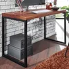 A desk in a room with a brick wall and a rug. Produktbild-Vorschau