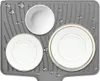 A gray silicone drying mat with water droplets, holding three white plates and a white bowl. The plates have a thin gold rim. Produktbild-Vorschau