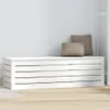 A white wooden storage chest with two brown pillows on top, placed against a light gray wall. Produktbild-Vorschau