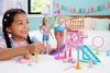 A young girl plays with a Barbie doll and a dog playground playset. Produktbild-Vorschau