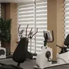 A gym with exercise equipment and blinds. Voir les images du produit