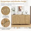 A wooden sideboard with rattan doors, decorated with framed pictures and a plant. Anteprima dell’immagine prodotto