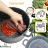 A hand is cleaning a pot with a red sauce inside, surrounded by fresh vegetables and icons indicating easy cleaning and dishwasher safety. Produktbild-Vorschau