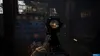 First-person perspective of aiming a weapon with a scope in a dark, industrial environment. Produktbild-Vorschau