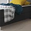 A close-up view of a bed with bedding. Produktbild-Vorschau