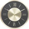 A close-up view of a modern wall clock with a black face and gold accents. Podgląd zdjęcia produktu