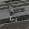 A close-up view of a gray suitcase with two zippers and a TSA combination lock. Produktbild-Vorschau
