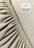A close-up view of a beige jersey fitted sheet, showing the elasticized edge. Produktbild-Vorschau