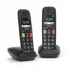 Two Gigaset E290 Duo cordless phones in their charging bases, shown from a diagonal angle against a white background. Podgląd zdjęcia produktu