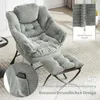 A light gray corduroy armchair with a matching ottoman, set in a living room environment. Náhled obrázku produktu