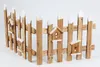 A small decorative wooden fence with birdhouses attached, set against a white background. Náhled obrázku produktu