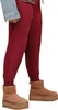 A person wearing UGG boots and red sweatpants. Produktbild-Vorschau