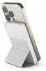 A white power bank with a stand attached to the back of a gold iPhone. Podgląd zdjęcia produktu