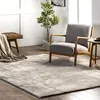A cozy living room scene with a rug, armchair, and bench. Produktbild-Vorschau
