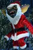 A Gremlin dressed as Santa Claus stands among evergreen branches. Produktbild-Vorschau