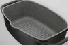 A close-up, angled view of the interior of a rectangular grill pan with a speckled non-stick coating and raised grill lines. Náhľad obrázku produktu