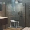 A modern bathroom with a shower, sink, and a shower stool. Produktbild-Vorschau