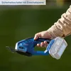A hand holding a cordless grass and shrub shear outdoors. Produktbild-Vorschau