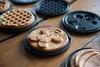 A collection of waffle molds with freshly made waffles on a wooden table. Podgląd zdjęcia produktu