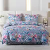 A neatly made bed with a floral patterned duvet and pillows. Produktbild-Vorschau