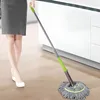 A person is using a mop to clean a floor in a kitchen or laundry room. Voir les images du produit