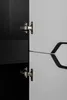 Close-up of a cabinet hinge and its reflection. Voir les images du produit
