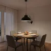 A dining table set for a meal, illuminated by a pendant lamp. Produktbild-Vorschau