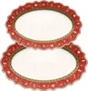 Two oval-shaped serving platters with a Christmas-themed red border are stacked on a white background. Anteprima dell’immagine prodotto