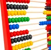 A close-up view of a colorful wooden abacus with beads of various colors arranged on wooden rods. Produktbild-Vorschau