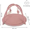 A pink baby play gym with hanging toys and dimensions indicated. Produktbild-Vorschau